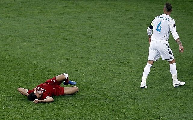 Real Madrid's Sergio Ramos, right, walks away after a collision with Liverpool's Mohamed Salah, left, during the Champions League Final soccer match between Real Madrid and Liverpool at the Olimpiyskiy Stadium in Kiev, Ukraine, May 26, 2018. (Darko Vojinovic/AP) Real Madrid's Sergio Ramos, right, walks away after a collision with Liverpool's Mohamed Salah, left, during the Champions League Final soccer match between Real Madrid and Liverpool at the Olimpiyskiy Stadium in Kiev, Ukraine, May 26, 2018. (Darko Vojinovic/AP)