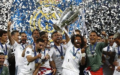 Real Madrid players celebrate with the trophy after winning the Champions League Final soccer match between Real Madrid and Liverpool at the Olimpiyskiy Stadium in Kiev, Ukraine, Saturday, May 26, 2018. (AP Photo/Matthias Schrader)