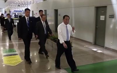 In this image made from video, Kim Yong Chol, right, a former military intelligence chief who is now Kim Jong Un's top official on inter-Korean relations, walks through Beijing airport after his arrival Tuesday, May 29, 2018. (AP Photo)