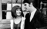 Undated image of Israeli singer and composer Abi Ofarim (Abraham Raichstadt) with an unlit cigarette in his mouth, right, and wife Esther Ofarim (Esther Zaid), strolling along a street in West Germany. (AP Photo)