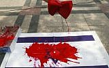 Illustrative photo of an Israeli flag daubed with red paint. (Ahn Young-joon/AP)