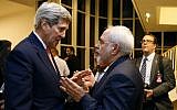 In this January 16, 2016 file photo, then-secretary of state John Kerry talks with Iranian Foreign Minister Mohammad Javad Zarif in Vienna, after the International Atomic Energy Agency (IAEA) verified that Iran has met all conditions under a nuclear deal. (Kevin Lamarque/Pool via AP, File)