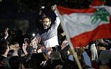 Ziad Itani, a Lebanese stage actor, who was indicted on charges of collaborating with Israel and drug possession, is carried by his neighbors and relatives after he was released by Lebanese authorities, at his house, in Beirut, Lebanon, Tuesday, March 13, 2018. (AP Photo/Hussein Malla)