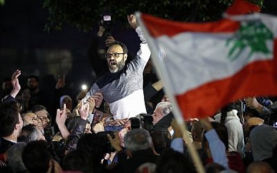 Ziad Itani, a Lebanese stage actor, who was indicted on charges of collaborating with Israel and drug possession, is carried by his neighbors and relatives after he was released by Lebanese authorities, at his house, in Beirut, Lebanon, Tuesday, March 13, 2018. (AP Photo/Hussein Malla)