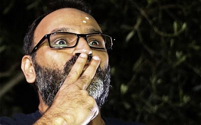 Ziad Itani, a Lebanese stage actor who was indicted on charges of collaborating with Israel and drug possession, sends kisses to his supporters after he was released by Lebanese authorities, at his house, in Beirut, Lebanon, Tuesday, March 13, 2018. (AP Photo/Hussein Malla)