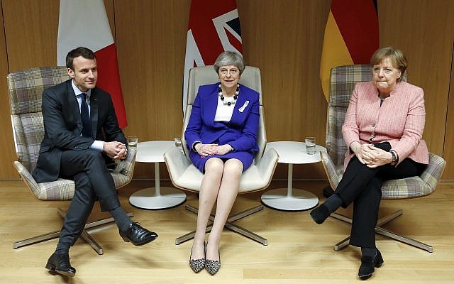 British Prime Minister Theresa May, center, German Chancellor Angela Merkel, right, and French President Emmanuel Macron, left, meet on the sidelines of an EU summit at the Europa building in Brussels on March 22, 2018. (Francois Lenoir, Pool Photo via AP)