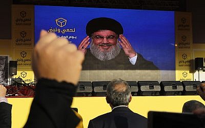 File: Hezbollah leader Hassan Nasrallah delivers a broadcast speech through a giant screen during an election campaign in the southern suburb of Beirut, Lebanon, Friday, April 13, 2018. (AP Photo/Hussein Malla)