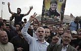 Hamas's leader in Gaza, Yahya Sinwar, center, chants slogans with protesters during a visit to the Gaza Strip's border with Israel, April 20, 2018. (AP Photo/Khalil Hamra)