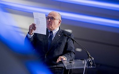 Rudy Giuliani, an attorney for President Donald Trump, pretends to spit on a piece of paper as he speaks about the Iran nuclear agreement at the Iran Freedom Convention for Human Rights and democracy, Saturday, May 5, 2018, in Washington. (AP Photo/Andrew Harnik)