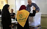 A Lebanese Hezbollah supporter casts a ballot at a polling station during the Lebanon's parliamentary elections in a southern suburb of Beirut, Lebanon, Sunday, May 6, 2018. (AP Photo/Hassan Ammar)