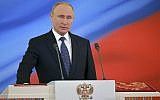 Vladimir Putin speaks with his hand on the Constitution during his inauguration ceremony as new Russian president in the Grand Kremlin Palace in Moscow, Russia, May 7, 2018. (Alexander Astafyev, Sputnik, Kremlin Pool Photo via AP)