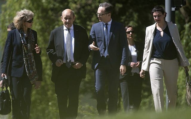 French foreign minister Jean-Yves Le Drian, second left, and his German counterpart Heiko Maas, third from left, take a stroll in the park of Villa Borsig in Berlin, Monday, May 7, 2018. (Ralf Hirschberger/dpa via AP) French foreign minister Jean-Yves Le Drian, second left, and his German counterpart Heiko Maas, third from left, take a stroll in the park of Villa Borsig in Berlin, Monday, May 7, 2018. (Ralf Hirschberger/dpa via AP)