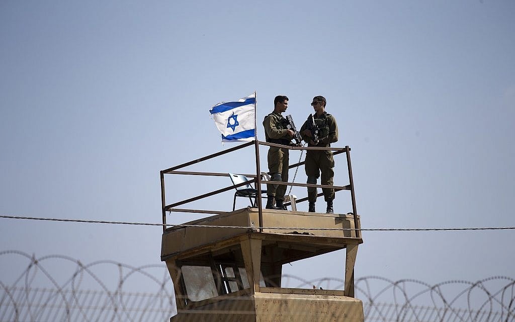 Israeli soldiers guard on top of a watch tower in a community along the Israel- Gaza Strip Border on May 15, 2018. (AP/Ariel Schalit)