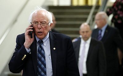 Sen. Bernie Sanders, I-Vt., talks on his phone as he departs after a vote on Gina Haspel to be CIA director, on Capitol Hill, Thursday, May 17, 2018 in Washington. (AP Photo/Alex Brandon)