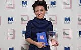 Polish author Olga Tokarczuk smiles after winning the Man Booker International prize 2018, Tuesday, May 22, 2018, for her book Flights, at the Victoria and Albert Museum in London. (Matt Crossick//PA via AP)