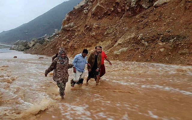 Men walk on a road flooded after heavy rain and strong winds caused damage in Hadibu as Cyclone Mekunu pounded the Yemeni island of Socotra, Thursday, May 24, 2018. (AP/Abdullah Morgan) Men walk on a road flooded after heavy rain and strong winds caused damage in Hadibu as Cyclone Mekunu pounded the Yemeni island of Socotra, Thursday, May 24, 2018. (AP/Abdullah Morgan)