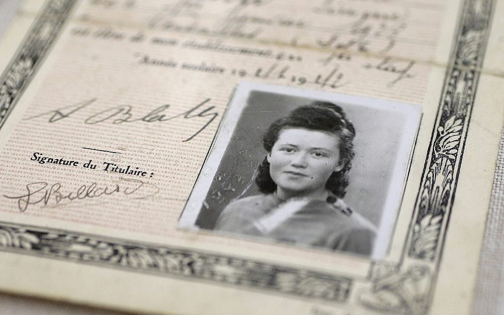 In this Monday, May 21, 2018, photo, a World War II-era, black-and-white photograph of French student Simone Billard is attached to a fake identity card created by the French Resistance in an exhibit called "Women in WWII: On the Home Fronts and the Battlefronts" at The International Museum of World War II, in Natick, Massachusetts. (AP Photo/Steven Senne)