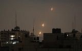 Illustrative: Flames from rockets fired by Palestinians are seen over Gaza Strip heading toward Israel, in the early morning of May 30, 2018. (AP Photo/Hatem Moussa)