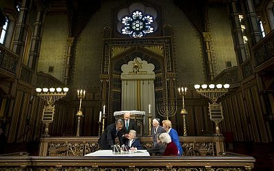 President Barack Obama and Swedish Prime Minister Fredrik Reinfeldt, center standing, listen to Nina Lagergren, 92, center, seated, as they look over artifacts and personal possession of Raoul Wallenberg at the Great Synagogue and Holocaust Memorial of Stockholm, Wednesday, September 4, 2013 in Stockholm. (AP/Pablo Martinez Monsivais)