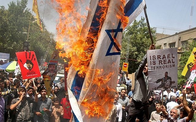 Illustrative: Iranians burn a representation of an Israeli flag as they chant slogans during an annual pro-Palestinian rally marking Al-Quds (Jerusalem) Day in Tehran, Iran, Friday, July 25, 2014. (AP Photo/Ebrahim Noroozi) Illustrative: Iranians burn a representation of an Israeli flag as they chant slogans during an annual pro-Palestinian rally marking Al-Quds (Jerusalem) Day in Tehran, Iran, Friday, July 25, 2014. (AP Photo/Ebrahim Noroozi)