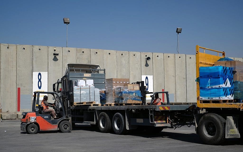 Workers load medical supplies onto a truck bound for the Gaza Strip at the Kerem Shalom Crossing on May 13, 2018. (Judah Ari Gross/Times of Israel) Workers load medical supplies onto a truck bound for the Gaza Strip at the Kerem Shalom Crossing on May 13, 2018. (Judah Ari Gross/Times of Israel)
