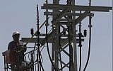 Illustrative image of an Israel Electricity Corporation worker raised by crane to a utility pole to perform maintenance works on June 10, 2013. (Flash 90)