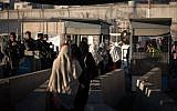 Palestinian women at the Qalandiya checkpoint outside of the West Bank city of Ramallah, on June 23, 2017. (Hadas Parush/Flash90/File)