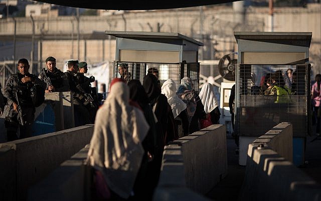 Palestinian women at the Qalandiya checkpoint outside of the West Bank city of Ramallah, on June 23, 2017. (Hadas Parush/Flash90/File)