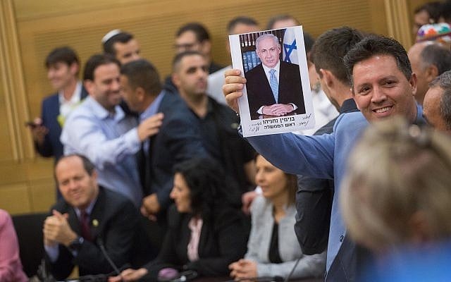 Supporters of Prime Minister Benjamin Netanyahu holding his signed picture, during a Likud party faction meeting at the Knesset on May 7, 2018. (Miriam Alster/Flash90) Supporters of Prime Minister Benjamin Netanyahu holding his signed picture, during a Likud party faction meeting at the Knesset on May 7, 2018. (Miriam Alster/Flash90)