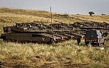 IDF soldiers beside tanks near the Israeli-Syrian border in the Golan Heights on May 10, 2018 (Basel Awidat/Flash90)