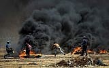 Palestinian protesters during clashes with Israeli forces along the border with the Gaza Strip, east of Gaza City, on May 11, 2018. (Abed Rahim Khatib/Flash90)
