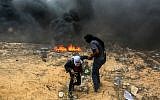 Palestinian protesters during clashes with Israeli forces near the Gaza-Israel border in Rafah, Gaza on May 14, 2018. (Abed Rahim Khatib/Flash90)