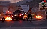 Illustrative: Palestinian protesters clash with Israeli security forces as demonstrations near the Hawara checkpoint, south of the West Bank city of Nablus May 14, 2018.  (Nasser Ishtayeh/Flash90)