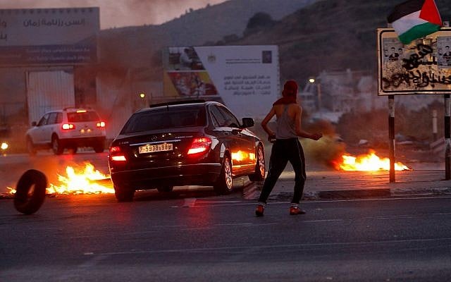 Illustrative: Palestinian protesters clash with Israeli security forces as demonstrations near the Hawara checkpoint, south of the West Bank city of Nablus May 14, 2018. (Nasser Ishtayeh/Flash90) Illustrative: Palestinian protesters clash with Israeli security forces as demonstrations near the Hawara checkpoint, south of the West Bank city of Nablus May 14, 2018. (Nasser Ishtayeh/Flash90)