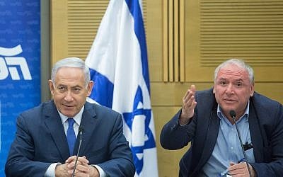 Prime Minister Benjamin Netanyahu, left, with coalition head Likud MK David Amsalem at a Likud party faction meeting in the Knesset on May 21, 2018. (Miriam Alster/Flash90)