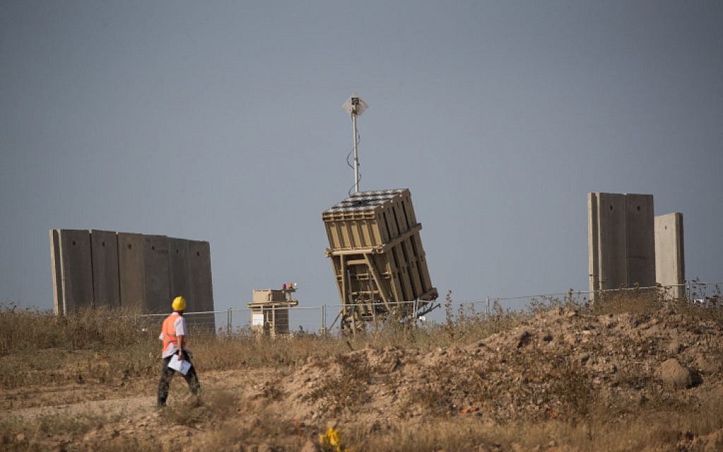 An operator walks by an Iron Dome missile defense battery near the city of Sderot in southern Israel on May 29, 2018. (Yonatan Sindel/Flash90)