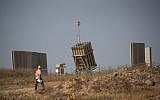An operator walks by an Iron Dome missile defense battery near the city of Sderot in southern Israel on May 29, 2018. (Yonatan Sindel/Flash90)