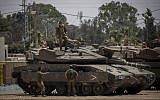 IDF soldiers seen near tanks at an army base near the border with the Gaza Strip, May 30, 2018. (Yonatan Sindel/Flash90)