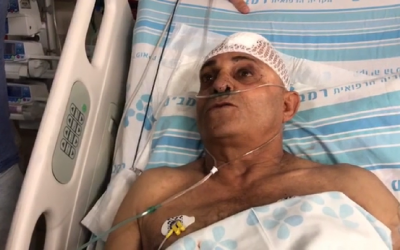Bus driver Shimon Gabai, who was stabbed in the northern city of Afula, speaks from his hospital bed on May 3, 2018. (Screen capture: Hadashot news)
