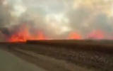A fire in agricultural fields near Kibbutz Be'eri in southern Israel that was reportedly started by flaming objects sent over the Gaza border, on May 7, 2018. (Screen capture: Twitter)