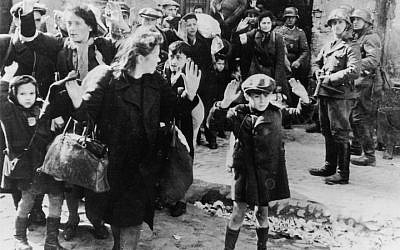 A Jewish boy surrenders in Warsaw -- the most well-known photograph taken during the 1943 Warsaw Ghetto uprising, in which a boy holds his hands over his head while SS-Rottenführer Josef Blösche points a submachine gun in his direction. (Wikipedia, public domain)