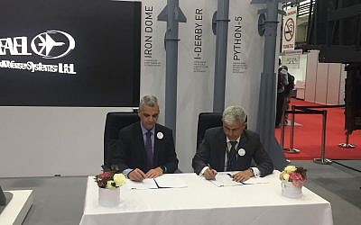Rafael Advanced Defense Systems director general Yoav Har-Even, left, signs an agreement of cooperation with 
director general of Ramaero, a Romanian developer, in Bucharest, May 16, 2018. (Rafael