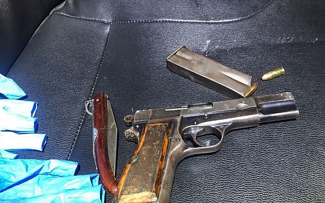 A pocket knife belonging to a Palestinian man arrested on May 24, 2018, south of Jerusalem after shooting at Border Police officers, and a pistol found nearby that was apparently used by him. (Israel Police)