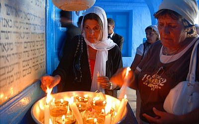 Jewish women light candles at the Ghriba synagogue in Djerba, Tunisia. (Larry Luxner/ Times of Israel)