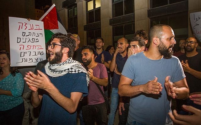 Activists protest against the arrest of 21 for protesting on Friday night in Haifa, outside the Haifa Magistrate's Court, May 20, 2018. (Meir Vaknin/Flash90) Activists protest against the arrest of 21 for protesting on Friday night in Haifa, outside the Haifa Magistrate's Court, May 20, 2018. (Meir Vaknin/Flash90)