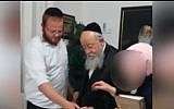 Baruch Klein (l) with his grandfather MK Menachem Eliezer Moses of UTJ. (Screen capture: Kann news)