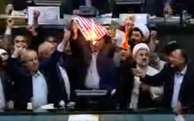 Iranian lawmakers burn paper US flag in parliament on May 9, 2018, after US President Donald Trump withdraws from nuclear deal. (Screen capture: Twitter)