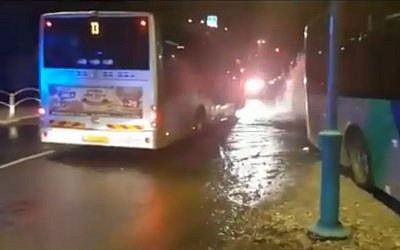 A bus in Afula that crashed into a fire hydrant after the driver was stabbed. (Screen capture/MDA)