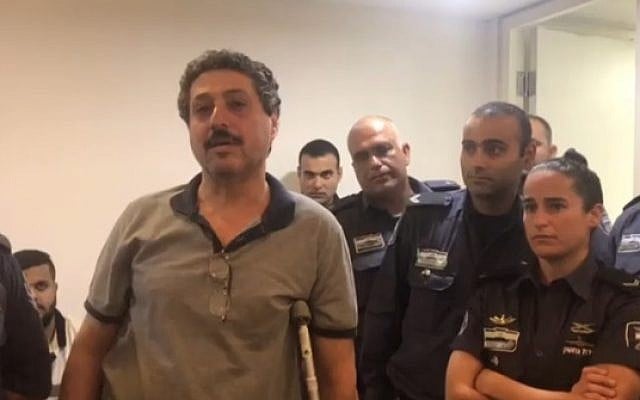 Arab-Israeli NGO worker Jafar Farah, who alleges a police officer broke his knee after he was arrested, in court on May 20, 2018. (Hadashot screenshot) Arab-Israeli NGO worker Jafar Farah, who alleges a police officer broke his knee after he was arrested, in court on May 20, 2018. (Hadashot screenshot)
