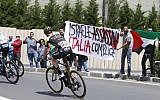 Anti-Israel protesters hold a banner reading 'Israel assassinates, Italy complicit' before the start of the 4th stage of the Giro d'Italia cycling race between Catania and Caltagirone in Sicily, May 8, 2017. (AFP PHOTO / Luk Benies)